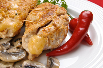 Stuffed fried chicken fillets with cheese, ham, and vegetables