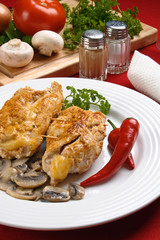 Stuffed fried chicken fillets with cheese, ham, and vegetables