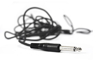Macro shot of wire with audio headphone connection plug.
