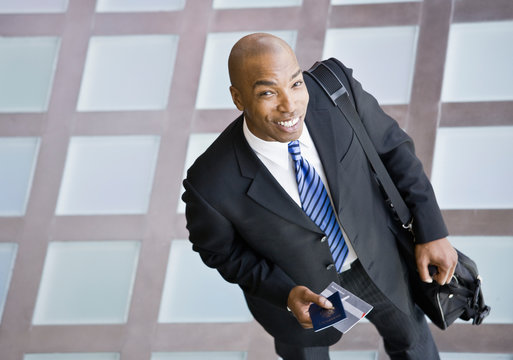 Businessman with briefcase and passport traveling