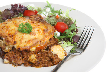 Moussaka with Greek salad isolated on white