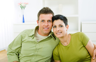 Obraz premium Happy love couple cuddling at home, smiling.