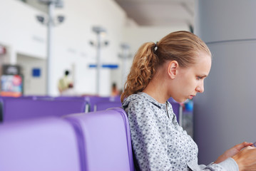 Fototapeta premium Woman at the airport, shallow DOF