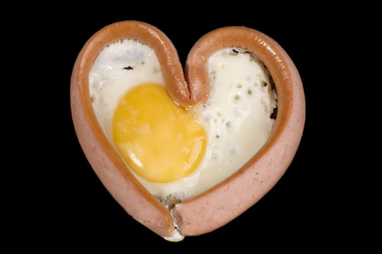object on black - food fried eggs with sausage