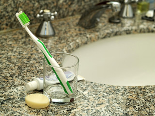 Toothpaste, toothbrush and soap on bathroom worktop