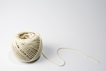 A ball of string on the lower left-hand side of a white frame