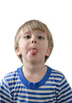 Little boy sticking out his tongue, white background