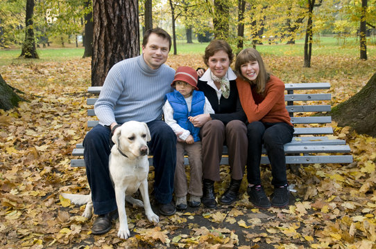 Happy family with dog at autumn time