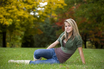 A beautiful blond teenage girl in the park