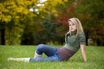 A beautiful blond teenage girl in the park