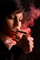 Fototapeta premium nice young girl is smoking in studio