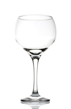Large clear empty wineglass isolated against white