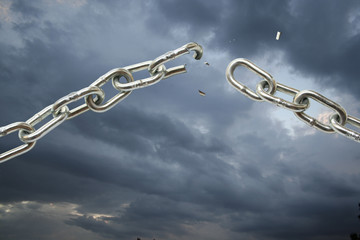 Broken chain on cloudy sky.