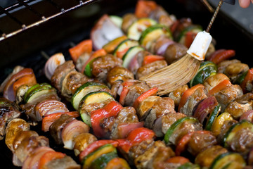 Beef shish kebabs on skewers, cooking on the grill.