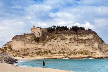 Man jogging on Tropea beach, Italy.