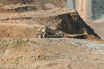 A Bulldozer working at a rock quarry