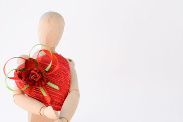 Mannequin holds heart shape gift