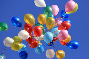A lot of balloons in the blue sky.
