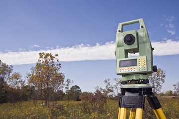 Fall time land surveying - total station set in the field.
