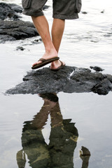 Man walking on lava rocks