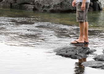 Man on lava rocks