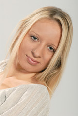 Naklejka premium close up portrait of cute young lady with straight blond hair