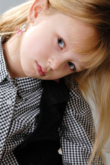 cute little blond girl with serious expression