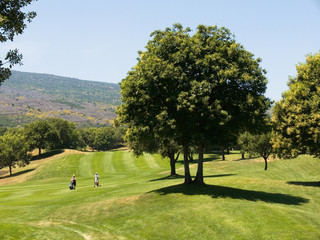 tow golfers walking on beautiful golf club