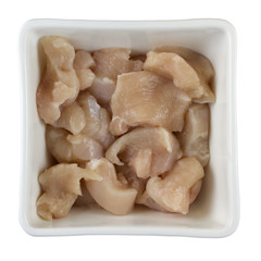 white, square bowl with chicken breast sliced for stir fry