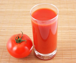 Tomato and tomato juice on wooden background