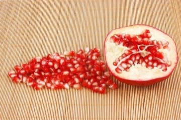 Ripe juicy pomegranate on wooden background