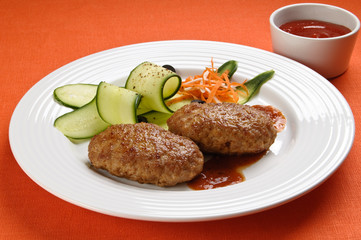 Fried steaks with vegetable salad
