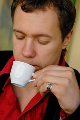 portrait of young man with cup of coffee