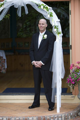 Groom standing at the wedding altar