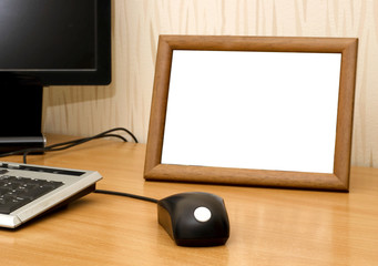 Empty photo frame on computer table