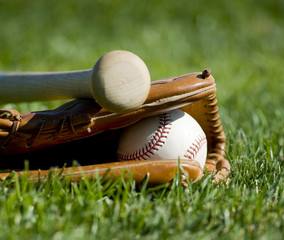 A baseball field with a leather baseball glove, a ball