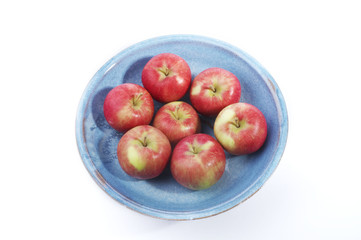 seven apples in a blue bowl