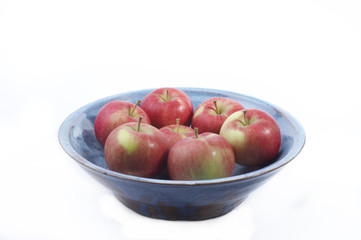 seven apples in a blue bowl