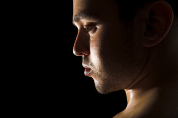 Young handsome man on black isolated background