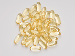 Vitamin Capsules randomly arranged on a white background