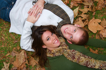 Young couple in an autumn forest picnic area
