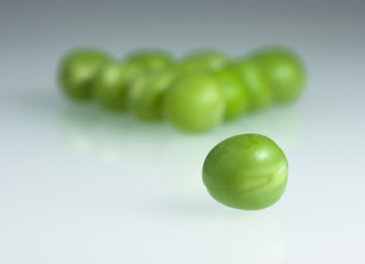 Green fresh peas arranged as pool balls