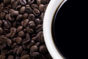 Closeup of coffee beans and cup