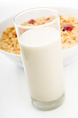 Glass of milk with dish of oat