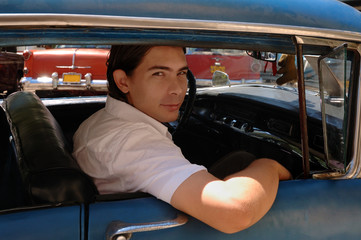 Man traveling inside classic american car in Old Havana