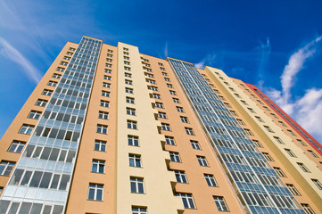 apartment block over blue sky