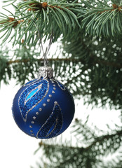 Christmas toy on a branch of a fur-tree