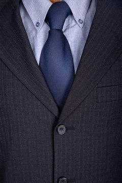 detail of a business man suit with blue tie