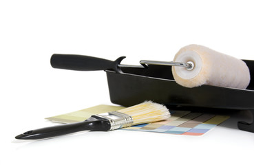 Painting supplies with a rolller, color swatches and paint brush