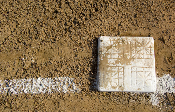Empty base on chalked baseball field,